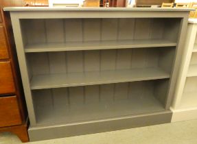 A modern grey painted pine dwarf bookcase with two height adjustable shelves, on a plinth  36"h