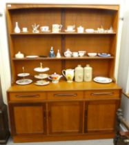 A G-Plan teak dresser, the upper part with boarded, two tier back, over a base of three frieze