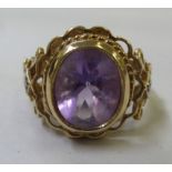 A 9ct gold fancy ring, set with a central amethyst and small diamond shoulders