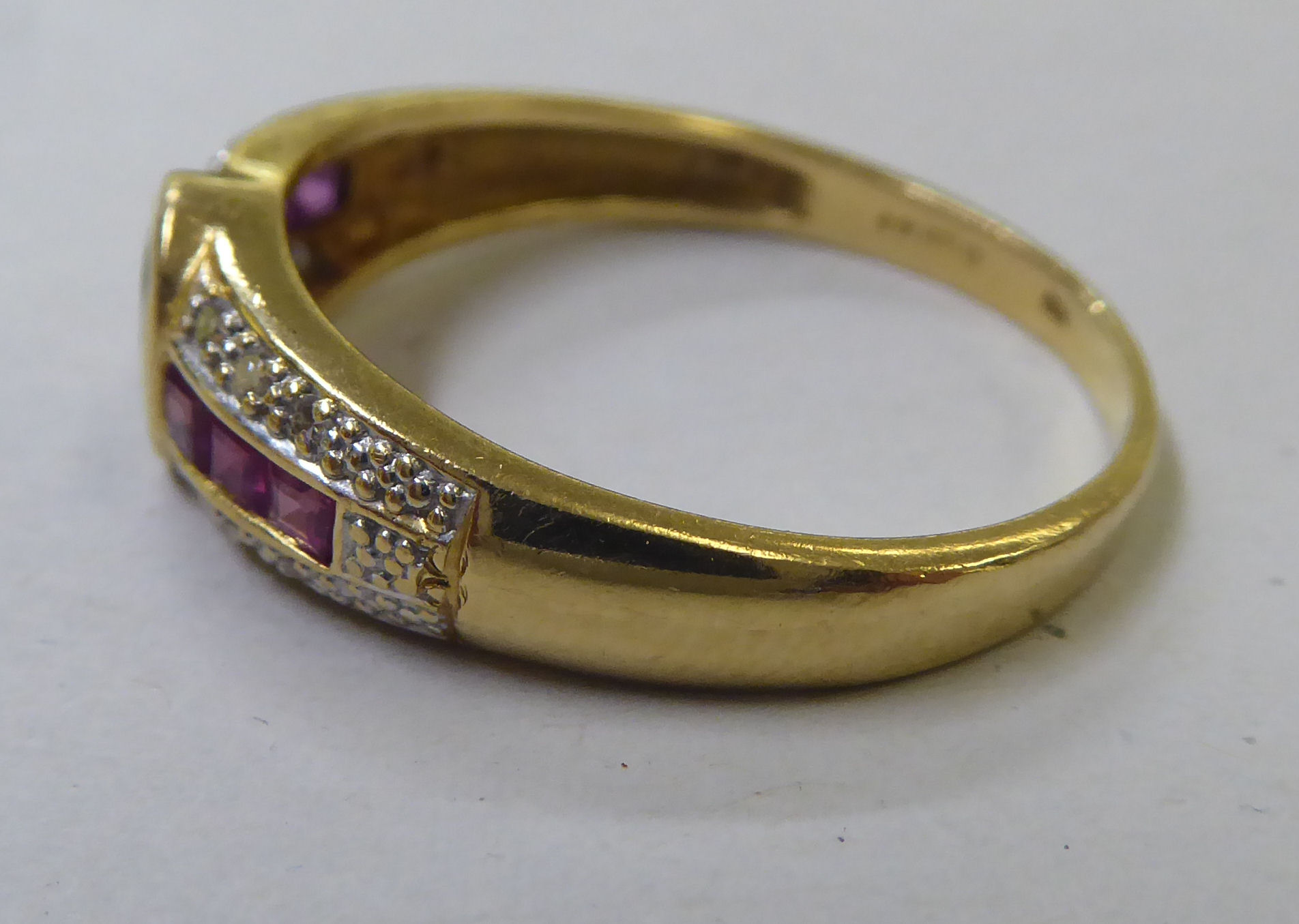 An 18ct gold ring, set with a central sapphire, ruby and diamond shoulders - Image 2 of 4