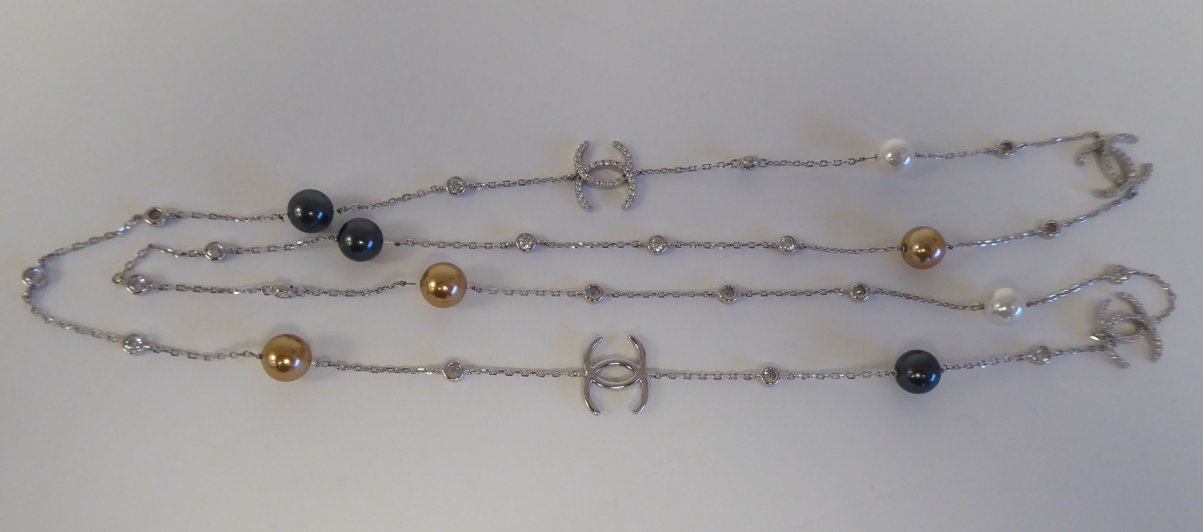 A silver coloured metal designer necklace set with freshwater pearl beads