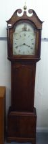 A 19thC oak longcase clock with an arched hood and window, over a straight trunk and a pendulum