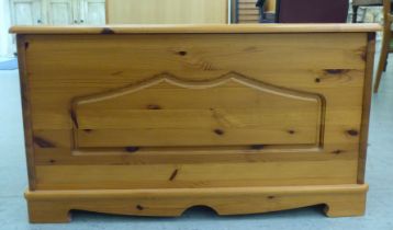 A modern waxed pine chest with a panelled front, straight sides and a hinged lid  18"h  32"w