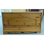 A modern waxed pine chest with a panelled front, straight sides and a hinged lid  18"h  32"w