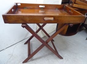 An early 20thC military design mahogany butler's tray with hinged ends, on a folding stand