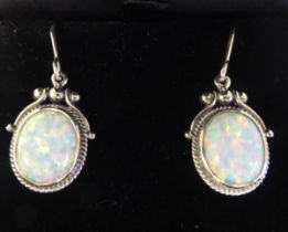 A pair of Art Nouveau style, silver coloured metal and opal set pendant earrings