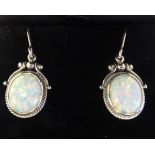 A pair of Art Nouveau style, silver coloured metal and opal set pendant earrings