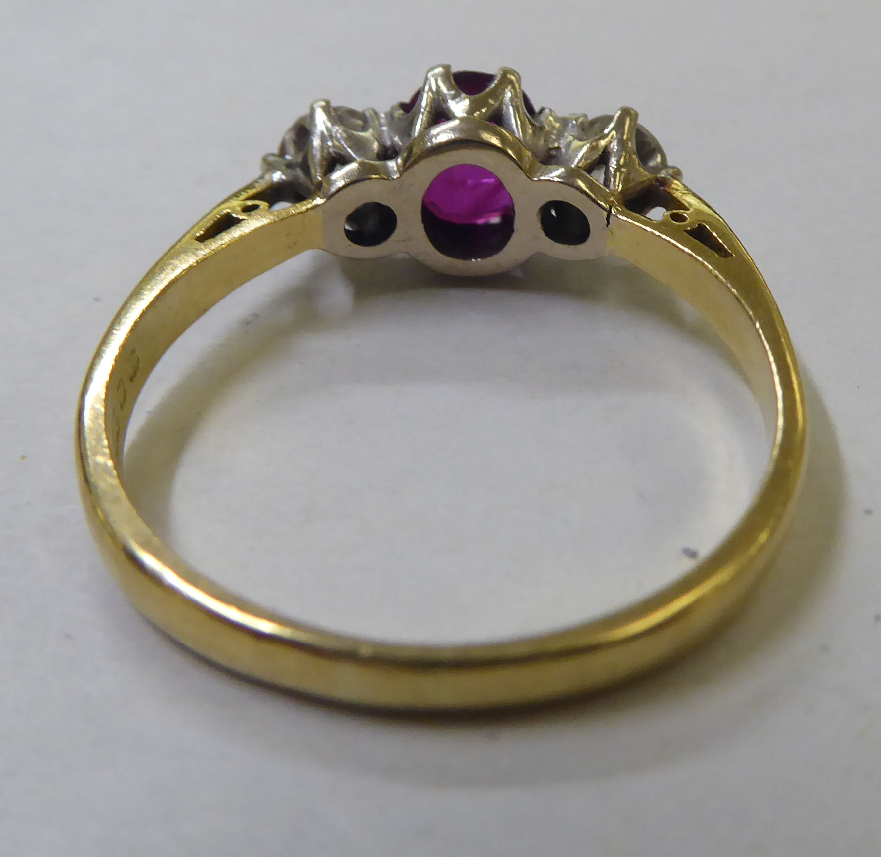 An 18ct gold ring, claw set with a central ruby, flanked by two diamonds - Image 3 of 4