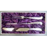 A loaded silver handled and stainless steel bladed, three piece carving set  modern London marks