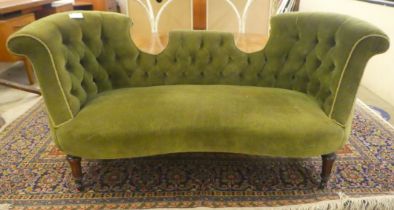 An Edwardian and later green fabric upholstered two person salon settee, raised on tapered, fluted