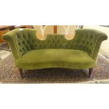 An Edwardian and later green fabric upholstered two person salon settee, raised on tapered, fluted