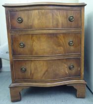 A modern mahogany, serpentine front, three drawer chest with ring handles, raised on bracket feet