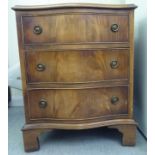 A modern mahogany, serpentine front, three drawer chest with ring handles, raised on bracket feet