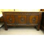 A mid/late 18thC oak coffer with straight sides and a hinged lid, over a tri-panelled front,