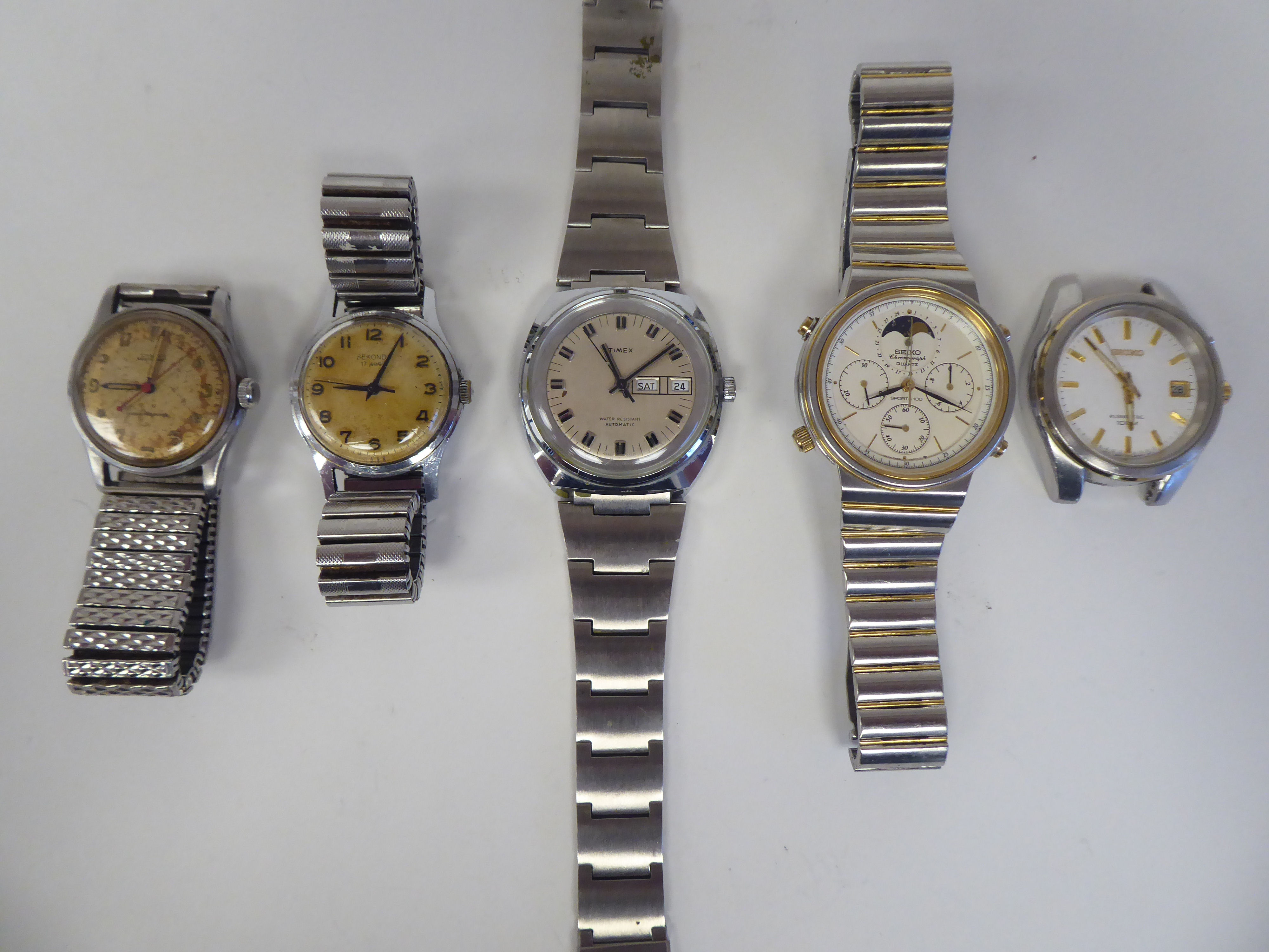 Four stainless steel cased and strapped wristwatches; and another unstrapped