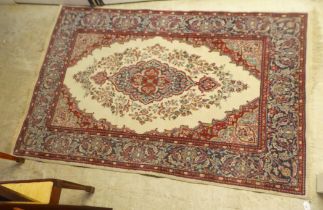 A Persian rug, decorated with stylised floral designs, on a multi-coloured ground  47" x 80"
