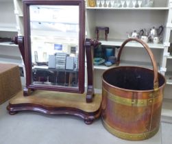 An Arts & Crafts rivetted copper coal bucket with a swing handle; and a later mahogany framed