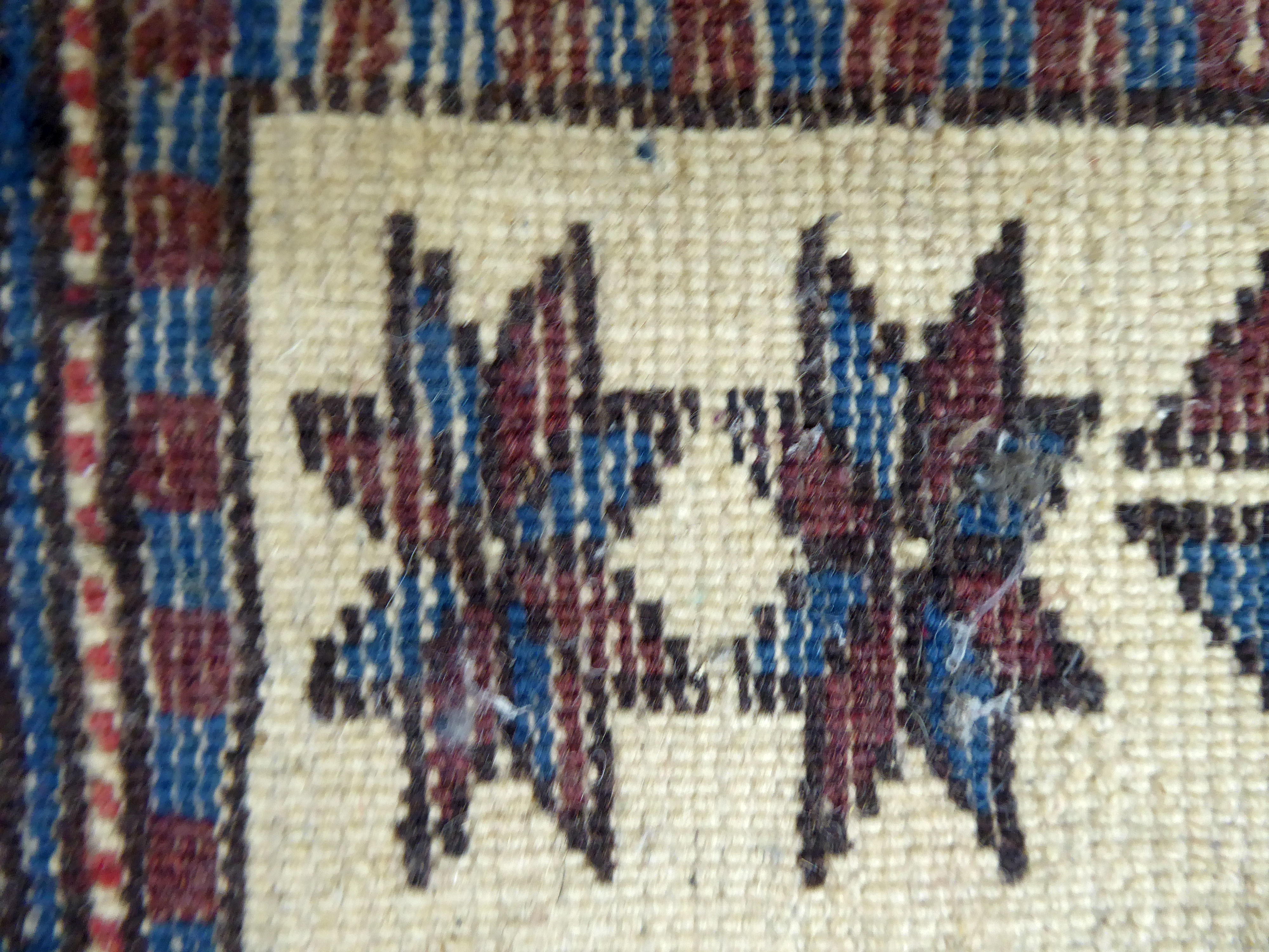 A North African rug, decorated with three octagonal motifs, bordered by repeating designs, on a - Image 5 of 5