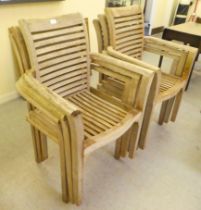 A set of six bleached teak framed open arm terrace chairs of slatted construction