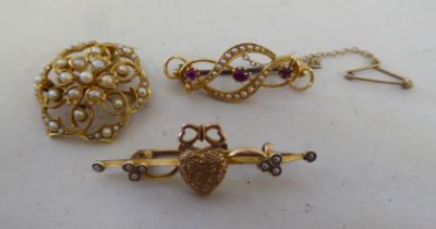 Three yellow metal brooches, viz. a bar brooch with love heart designs, adorned with seed pearls