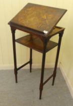 An early 20thC oak and parquetry two tier stand, the uppermost incorporating a reading lectum, on