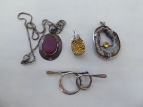 Silver and white metal jewellery, viz. three pendants; and a bar brooch of spiral design