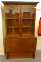 A late Victorian mahogany cabinet bookcase with two glazed doors, over a fall-flap front, flanked by