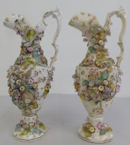 A pair of late 19thC, probably Coalport, china ewers, each encrusted with flora  13"h