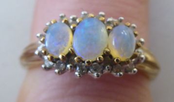 A 9ct gold opal and diamond cluster ring