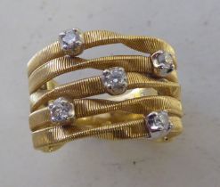 An 18ct gold Marco Bicego ring, fashioned as coiling straps, set with diamonds