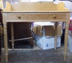 A late 19th/early 20thC bleached pine washstand with a frieze drawer, raised on turned legs  39"h