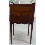 A George III mahogany night commode with a shallow gallery top, over a cupboard door, raised on