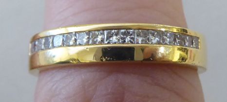 An 18ct gold ring, set with a band of pave set, cut diamonds
