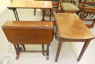 An early 20thC mahogany Pembroke style coffee table with an oval top, over an end drawer, raised