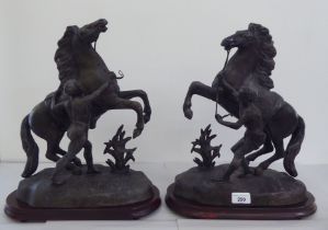 A pair of patinated spelter Marley horses, on wooden plinths  17"h
