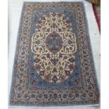 A Persian part silk woven rug, decorated with floral designs, on a cream coloured, pale blue and