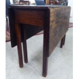 A George III mahogany drop-leaf table, raised on square legs  28"h  39"L extending to  46"L