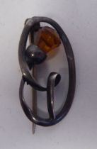 A Charles Horner silver wire thistle brooch, set with an amber coloured stone