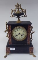 A late 19thC black slate, marble and gilt metal cased mantel clock, surmounted by a twin handled