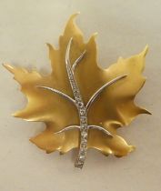 A Birks 14ct gold maple leaf design brooch, set with diamonds