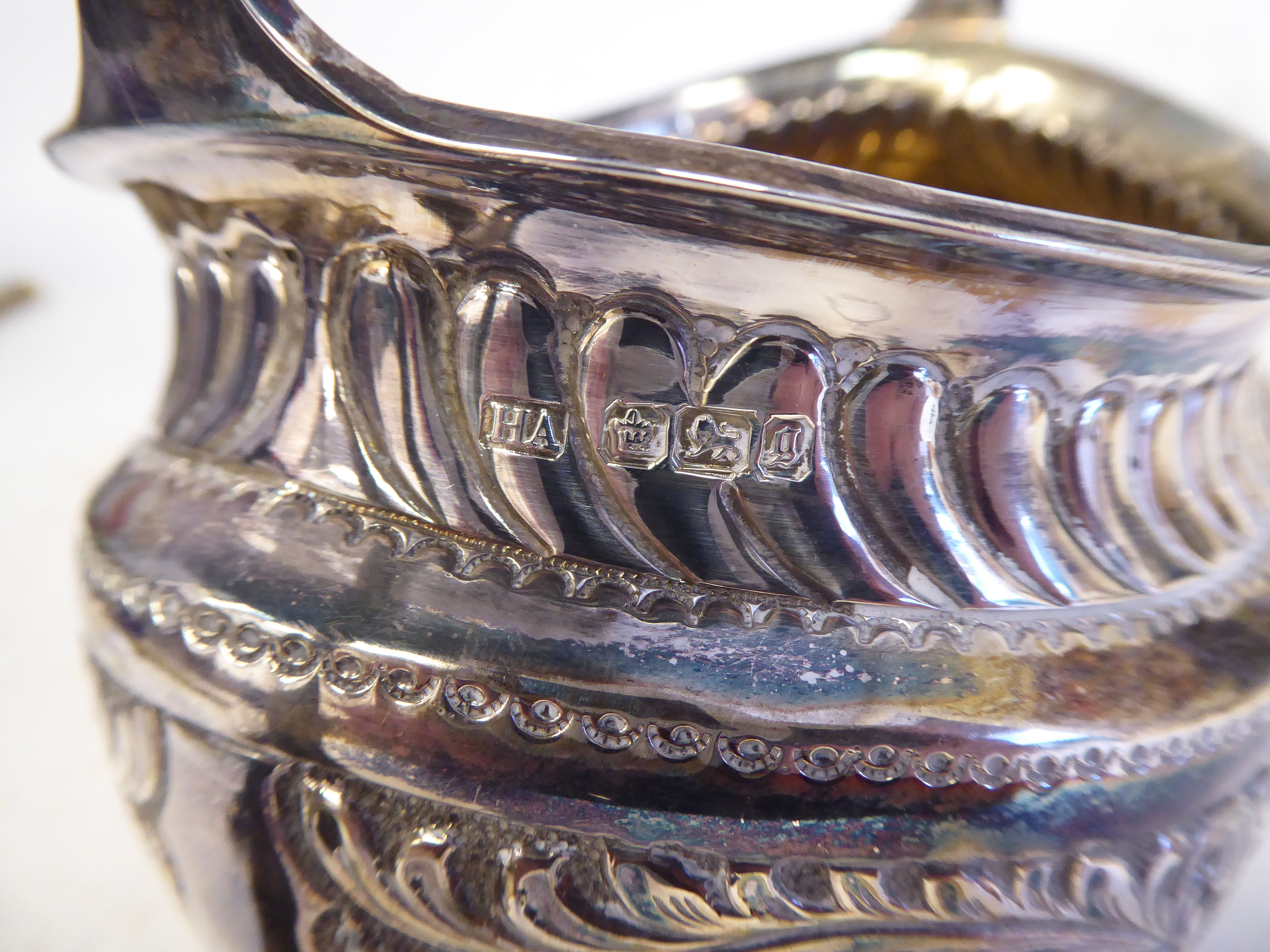 A late Victorian silver three piece tea set of oval form with engraved, chased and demi-reeded - Image 7 of 10