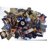 A miscellaneous collection of military and related embroidered and printed uniform badges and