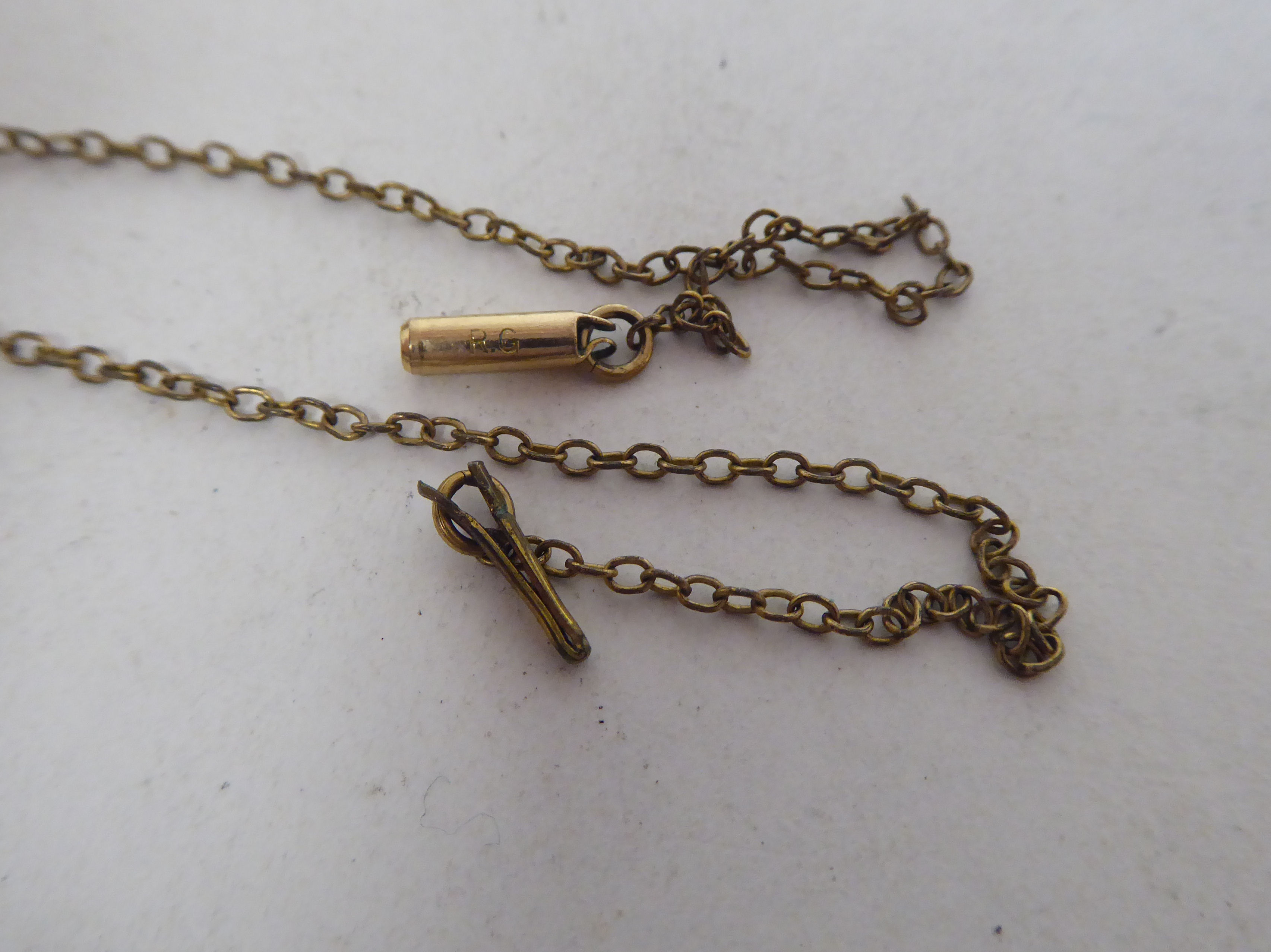 A late Victorian foliate scrolled yellow metal locket, fashioned as a book, on a clasp, revealing - Image 7 of 7