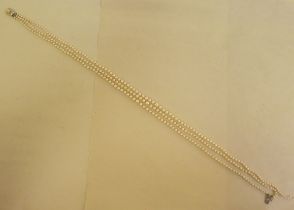 A triple string, graduated cultured pearl necklace