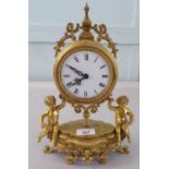 A mid 20thC Victorian design gilt metal mantel clock; the drum design movement faced by an enamelled