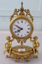 A mid 20thC Victorian design gilt metal mantel clock; the drum design movement faced by an enamelled