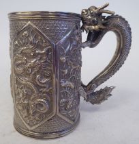 A late 19thC Chinese silver coloured metal mug of tapered cylindrical form with a cast S-shape