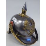 A German Great War spiked, polished steel and brass cavalry helmet with a hide liner and