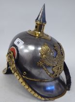 A German Great War spiked, polished steel and brass cavalry helmet with a hide liner and