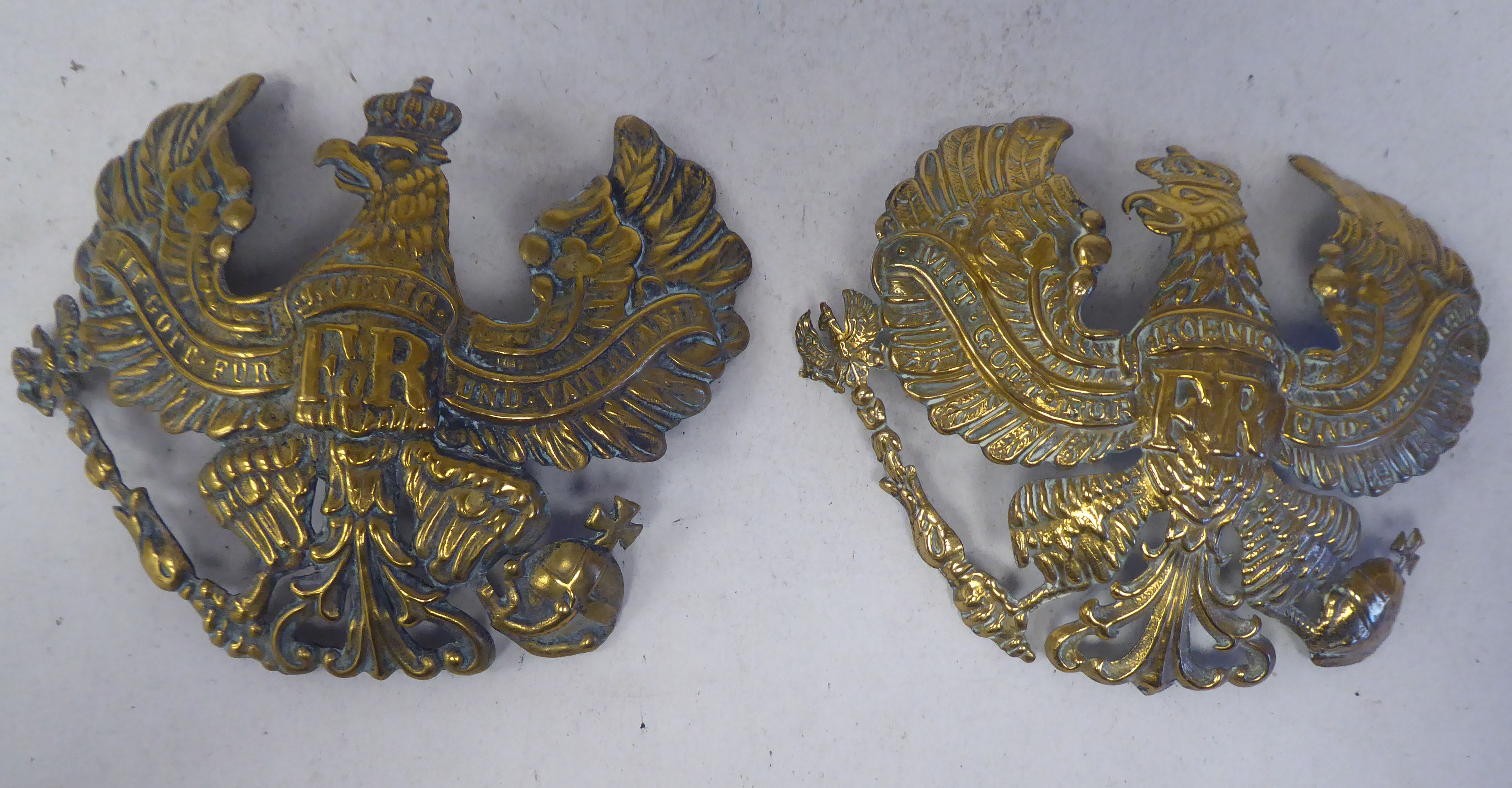 Two identical German Great War brass helmet plates (Please Note: this lot is subject to the